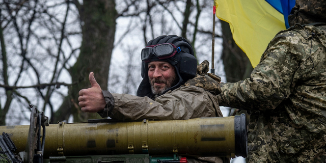 A Ukrainian soldier rides atop an armored fighting vehicle in eastern Ukraine on Tuesday. 