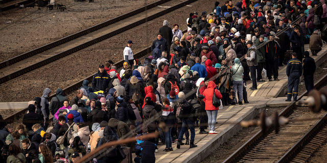 Ukrainian families wait to board a train at Kramatorsk central station as they flee the eastern city of Kramatorsk, in the Donbas region, in early April.