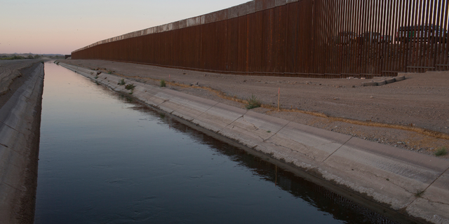 Border Patrol vehicles are stationed at a popular crossing point for migrants from Central America on April 29, 2021 near Yuma, Arizona.