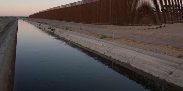 Border Patrol vehicles are stationed at a popular crossing point for Central American immigrants on April 29, 2021, near Yuma, Arizona.