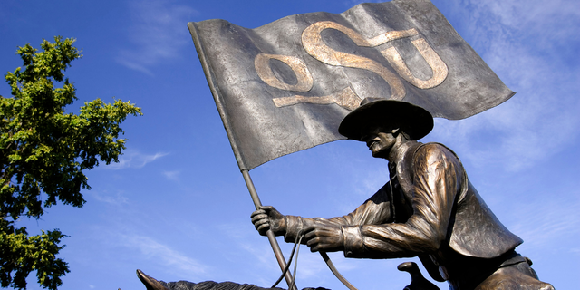 Bronze statue of an OSU cowboy outside Pickens Stadium on the campus of Oklahoma State University October 1, 2005 in Stillwater, Oklahoma. 