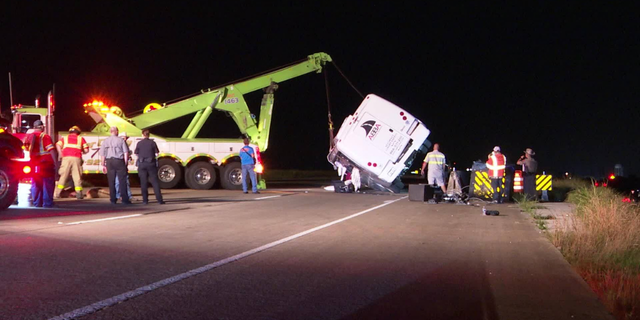 A bus carrying members of a baseball team rolled over on a Texas highway, sending 12 people to the hospital.