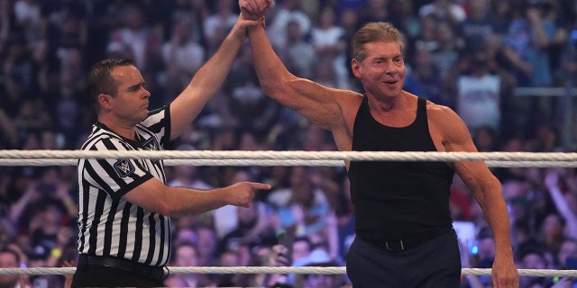WWE owner Vince McMahon celebrates during WrestleMania at AT&T Stadium.