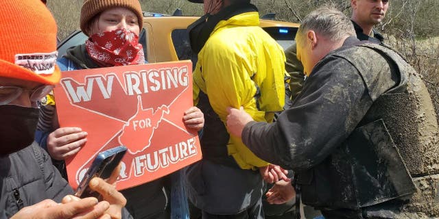 Climate activists protest Joe Manchin at a West Virginia power plant.
