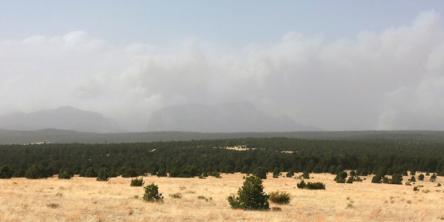 Plumes of smoke rise from a pair of growing wildfires in northeast New Mexico on Friday, April 22, 2022, outside Las Vegas, New Mexico. Southwest fires have burned dozens of homes in northern Arizona and put numerous small villages in New Mexico in the path of danger.