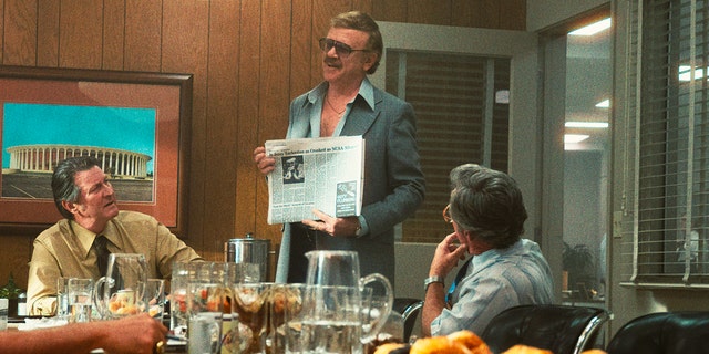 This image released by HBO shows Brett Cullen, portraying Bill Sharman, left, and John C. Reilly, portraying Jerry Buss, standing, in a scene from the series "Winning Time: The Rise of the Lakers Dynasty."