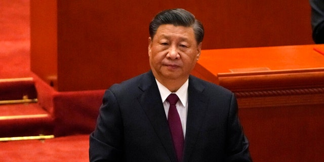 Chinese President Xi Jinping attends a commendation ceremony for role models of the Beijing Winter Olympics and Paralympics at the Great Hall of the People on April 8 in Beijing. An Australian man provoked anger from supporters of Xi by holding a sign at a Sydney marker insulting the communist leader.