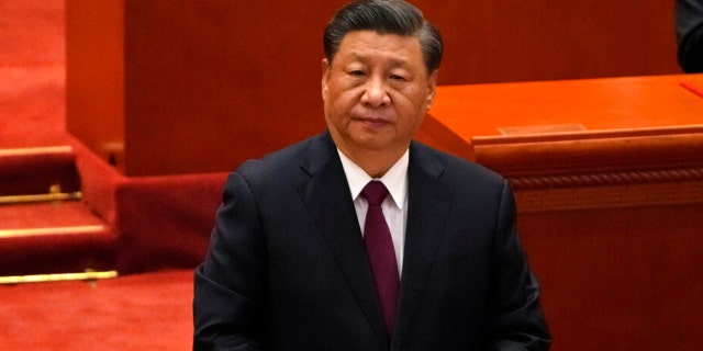 Chinese President Xi Jinping attends a commendation ceremony for role models of the Beijing Winter Olympics and Paralympics at the Great Hall of the People on April 8 in Beijing. An Australian man provoked anger from supporters of Xi by holding a sign at a Sydney marker insulting the communist leader.