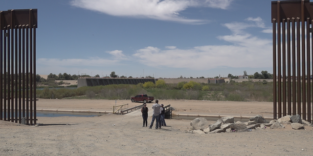 Yuma residents at the gap in the border wall into Mexico.