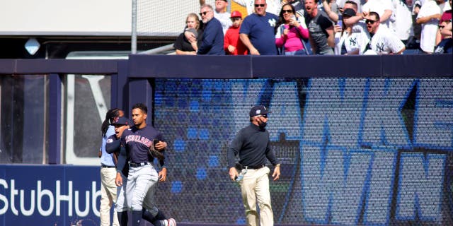 Yankees fans hurl trash at Guardians players 2 Oscar Mercado #35 of the Cleveland Guardians is restrained as fans throw debris on the field following Gleyber Torres #25 of the New York Yankees walk off RBI single in the bottom of the ninth inning at Yankee Stadium on April 23, 2022 in New York City.