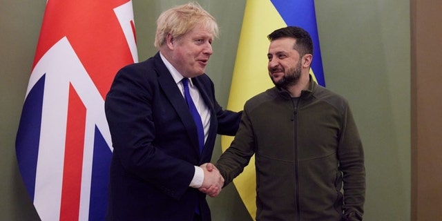 Then-U.K. Prime Minister Boris Johnson, left, and Ukrainian President Volodymyr Zelenskyy shake hands in Kyiv on March 9, 2022.
