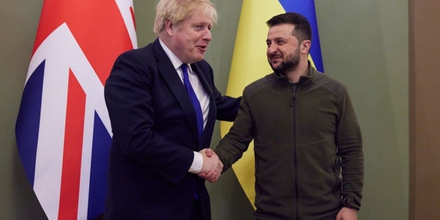 Then UK Prime Minister Boris Johnson, left, and Ukraine's President Volodymyr Zelenskyy shake hands in Kyiv on March 9, 2022.