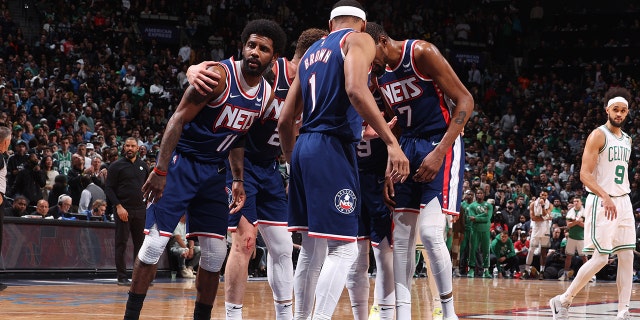 Kyrie Irving huddles with his Brooklyn Nets teammates on April 25, 2022, at Barclays Center in Brooklyn.