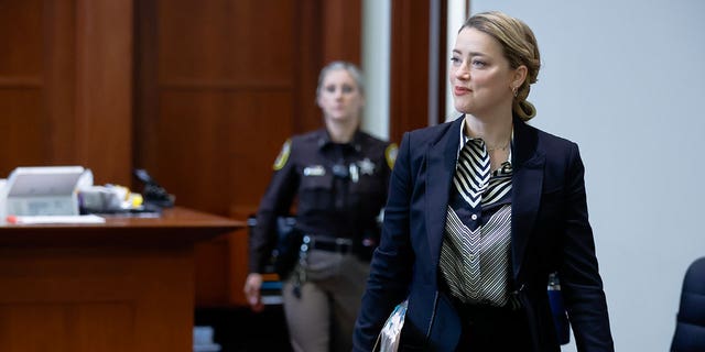 Actor Amber Heard arrives in the courtroom at the Fairfax County Circuit Court in Fairfax, Va., Wednesday, April 27, 2022. Actor Johnny Depp sued his ex-wife actress Amber Heard for libel in Fairfax County Circuit Court after she wrote an op-ed piece in The Washington Post in 2018 referring to herself as a "public figure representing domestic abuse." 