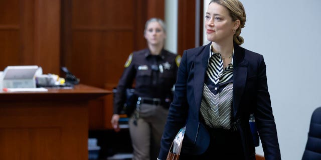 Actor Amber Heard arrives in the courtroom at the Fairfax County Circuit Court in Fairfax, Va., Wednesday, April 27, 2022. Actor Johnny Depp sued his ex-wife actress Amber Heard for libel in Fairfax County Circuit Court after she wrote an op-ed piece in The Washington Post in 2018 referring to herself as a "public figure representing domestic abuse."