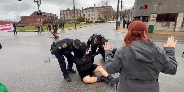Wilkinsburg police officers arrest an activist at a Black Lives Matter protest. (courtesty, Twitter: @WickPhoto)