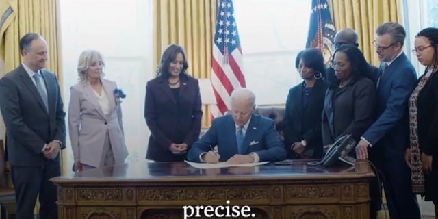 President Biden, along with others, including Vice President Kamala Harris and Judge Ketanji Brown Jackson, are seen maskless in the Oval Office.