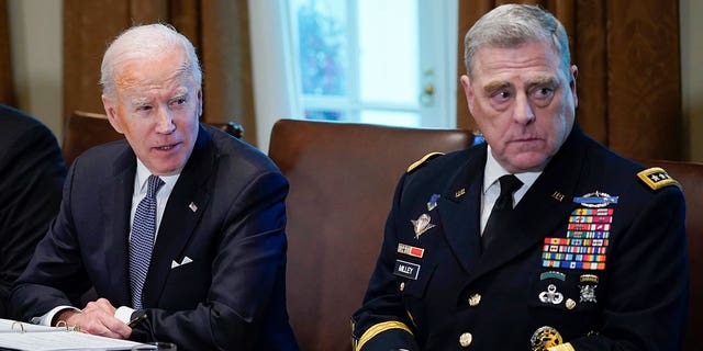 President Joe Biden and Chairman of the Joint Chiefs of Staff Gen. Mark Milley listen during a meeting with military leaders in the Cabinet Room of the White House, Wednesday, April 20, 2022, in Washington. 