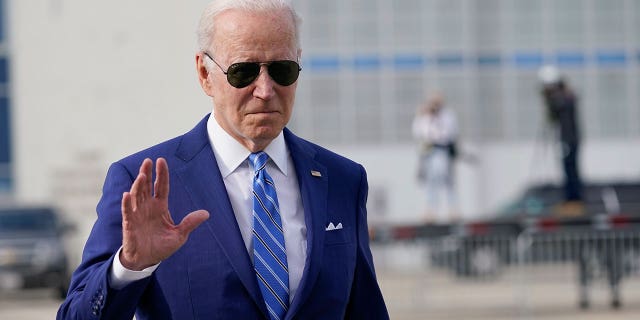 President Joe Biden waves boarding Air Force One in Des Moines Iowa, Tuesday, April 12, 2022.