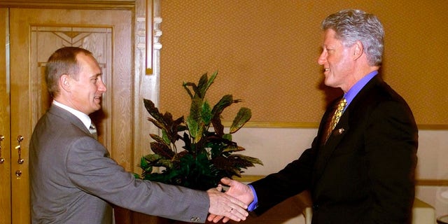 U.S. President Bill Clinton shakes hands with Russian President Vladimir Putin at the Assara Guest House during the Asia-Pacific Economic Cooperation annual meeting in Brunei, November 15, 2000.