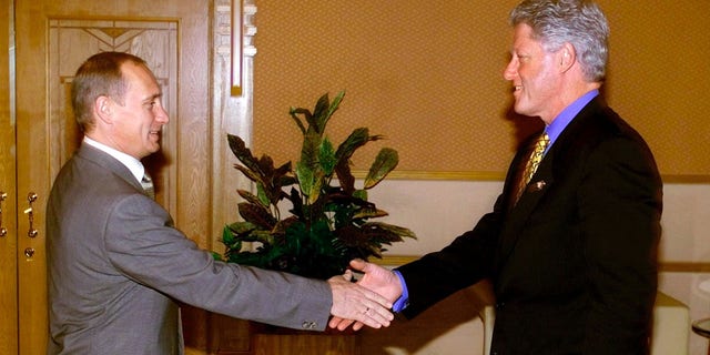 U.S. President Bill Clinton shakes hands with Russian President Vladimir Putin at the Assara Guest House during the Asia-Pacific Economic Cooperation annual meeting in Brunei, November 15, 2000.