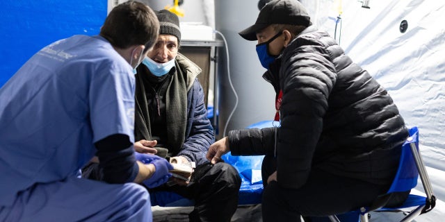 Volunteers tend to an injured and displaced Ukrainian man amid the war.