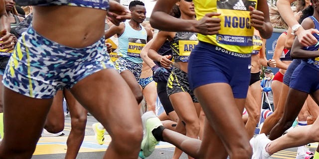 Diana Kipyogei of Kenya, center, at the start of the 125th Boston Marathon on Oct. 11, 2021, in Hopkinton, Massachusetts.