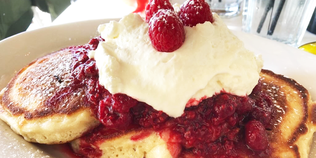 Raspberry-smothered pancakes topped with whipped cream served at Briarpatch restaurant in Winter Park, Fla., Jan. 5, 2022. (Madison McCarthy)