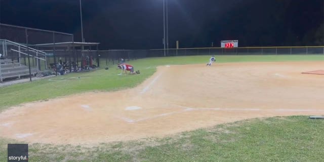 Children and coaches duck for cover as gunshots ring through the stadium.