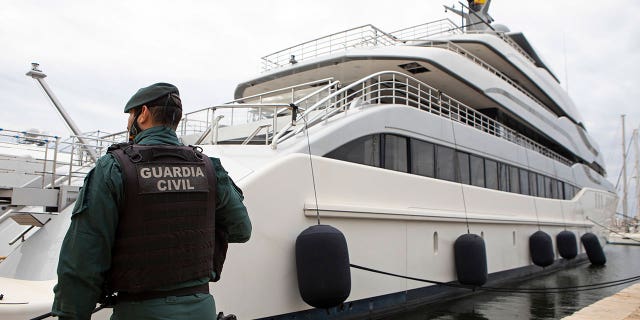A Civil Guard stands by a Russian oligarch-owned yacht called Tango in Palma de Mallorca, Spain, Monday April 4, 2022.
