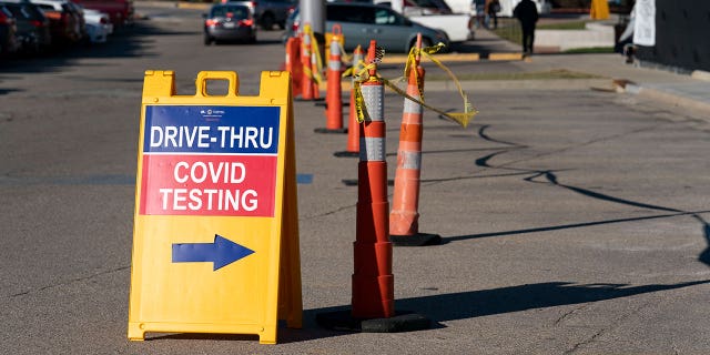 FILE - A sign points to a COVID testing site at the Cincinnati Veterans Affairs Medical Center in Cincinnati, on Jan. 3, 2022.                             (AP Photo/Jeff Dean, File)