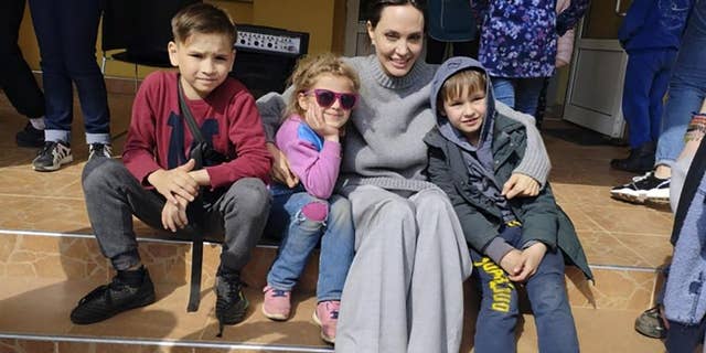 Angelina Jolie, UNHCR goodwill ambassador, poses with children in Lviv, Ukraine, April 30, 2022.