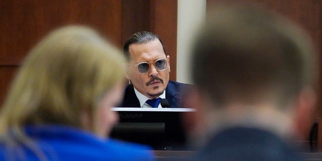 Actor Johnny Depp testifies in the courtroom at the Fairfax County Circuit Courthouse in Fairfax, Virginia April 25, 2022. 