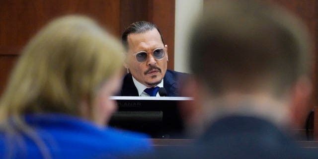 Actor Johnny Depp testifies in the courtroom at the Fairfax County Circuit Courthouse in Fairfax, Virginia April 25, 2022. 