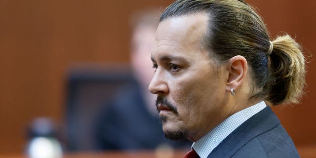 Actor Johnny Depp listens in court in Fairfax County Circuit Court in Fairfax, Virginia.  (Jonathan Ernst/Pool photo via The Associated Press)