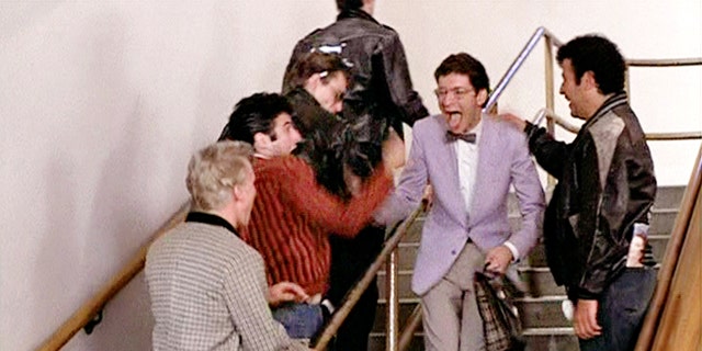 LOS ANGELES - JUNE 16: The movie "Grease", directed by Randal Kleiser. Seen here, the T-Birds prank on Eugene (wearing glasses and bow tie), played by Eddie Deezen. Initial theatrical release of the film, June 16, 1978. Screen capture. Paramount Pictures. (Photo by CBS via Getty Images)