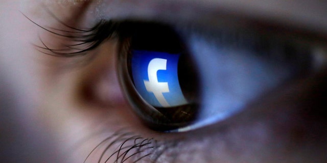 FILE PHOTO: A picture illustration shows a Facebook logo reflected in a person's eye.