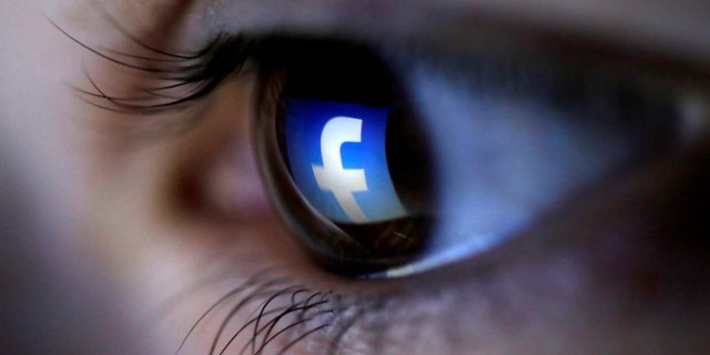 FILE PHOTO: A picture illustration shows a Facebook logo reflected in a person's eye.