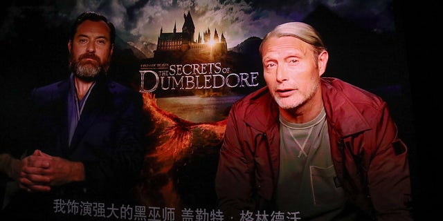 BEIJING, CHINA - APRIL 06: A screen shows actor Jude Law and actor Mads Mikkelsen speaking via video link during 'Fantastic Beasts: The Secrets of Dumbledore' premiere at a cinema on April 6, 2022 in Beijing, China.  (Photo by VCG/VCG via Getty Images)