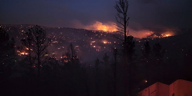Fire burns along a hillside in the Village of Ruidoso, N.M., on Wednesday, April 13, 2022. 
