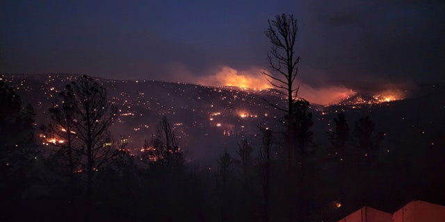 Fire burns along a hillside in the Village of Ruidoso, N.M., on Wednesday, April 13, 2022. 