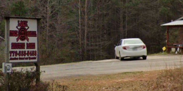 A sign for the Lock Stock & Barrel Shooting Range in Coweta County, Georgia, is seen from the street.