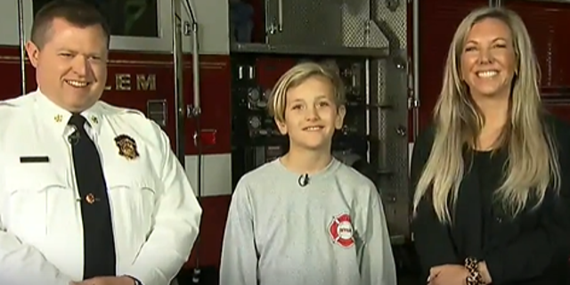 Jackson Gilchrist (center) with his mother Dayna Gilchrist as well as fire chief Larry Best joined "Fox and Friends" to celebrate the fifth grader's kind gesture to the Salem Fire Department, on April 6, 2022. (Fox News)