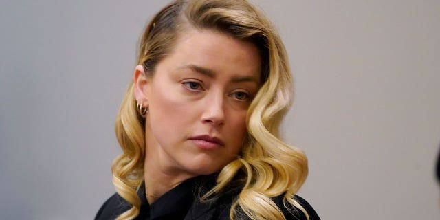 Actress Amber Heard listens in the courtroom at the Fairfax County Circuit Court in Fairfax, Va., Monday April 18, 2022. Actor Johnny Depp sued his ex-wife Amber Heard for libel in Fairfax County Circuit Court after she wrote an op-ed piece in The Washington Post in 2018 referring to herself as a "public figure representing domestic abuse." (AP Photo/Steve Helber)