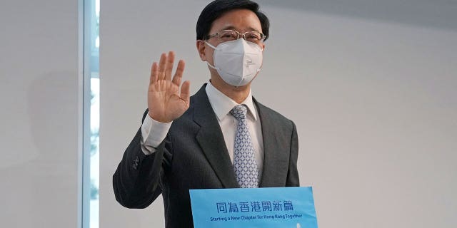 Former Hong Kong Chief Secretary John Lee poses for a photograph before submitting his candidacy for the election of the chief executive, in Hong Kong, Wednesday, April 13, 2022.