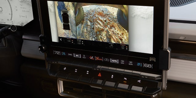 A 360-degree camera system includes views under the vehicle and a washing mechanism for the underbody cameras.