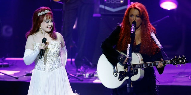 LAS VEGAS, NV - OCTOBER 07: Recording artists Naomi Judd (L) and Wynonna Judd perform during the launch of their nine-show residency "Girls Night Out" at The Venetian Las Vegas on October 7, 2015 in Las Vegas, Nevada. (Photo by Isaac Brekken/Getty Images)