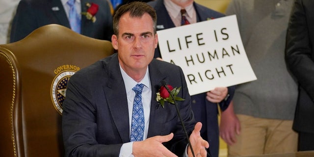 Oklahoma Gov. Kevin Stitt speaks after signing into law a bill making it a felony to perform an abortion, punishable by up to 10 years in prison, Tuesday, April 12, 2022, in Oklahoma City. 