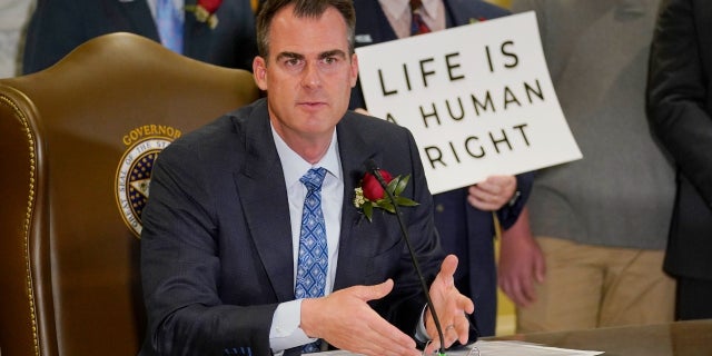 Oklahoma Gov. Kevin Stitt speaks after signing into law a bill making it a felony to perform an abortion, punishable by up to 10 years in prison, April 12, 2022, in Oklahoma City.