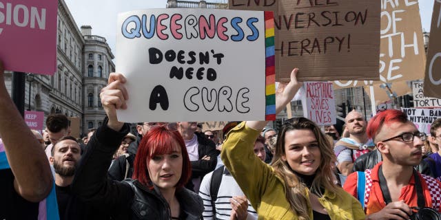 LGBT activists, transgender people and their supporters demonstrate outside Downing Street in a protest the UK governments decision to exclude transgender people in a conversion therapy ban on April 10, 2022, in London, England. (Photo credit should read Wiktor Szymanowicz/Future Publishing via Getty Images)